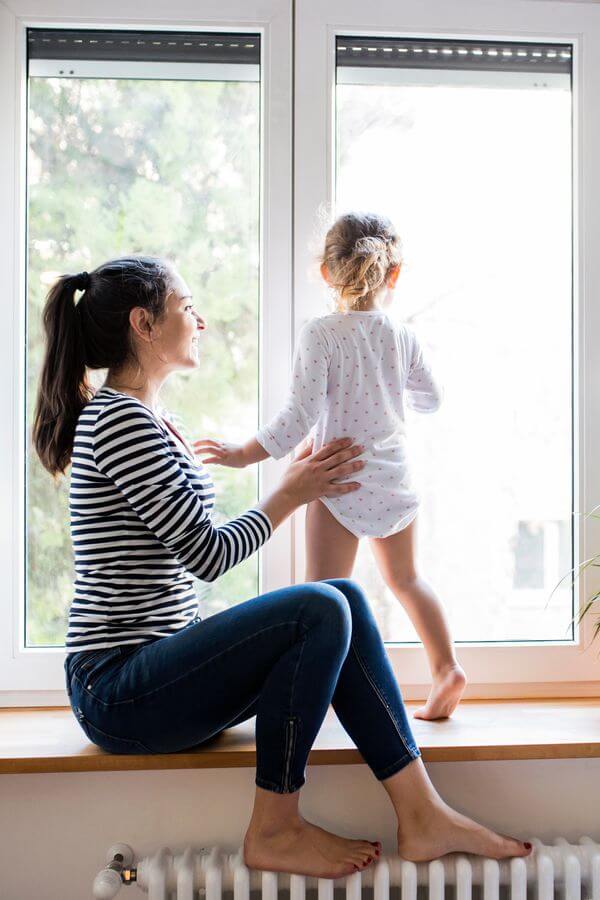 family sitting on window ledge